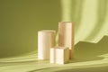 Square wooden stands of various heights on green background for product demonstration. Shadows in form of lines fall on