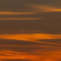 Squared image of beautiful red sunset sky with clouds.