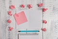 Squared open spiral notebook sticky note clip highlighter crushed colored paper balls lying wooden retro vintage rustic