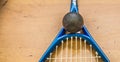 Squash ball on court with squash racket ready to play new game Royalty Free Stock Photo