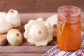 Squash caviar in a jar on the table on wooden table with white squash