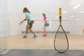 Squash game concept with racket leaned on net and sportspeople playing