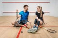 Squash game concept, young couple, rackets, ball Royalty Free Stock Photo