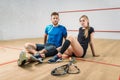 Squash game concept, young couple, rackets, ball Royalty Free Stock Photo