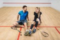 Squash game concept, young couple, rackets, ball Royalty Free Stock Photo