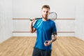 Squash game player with racket and ball in hands Royalty Free Stock Photo