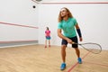 Squash male player with racket playing game with female friend Royalty Free Stock Photo