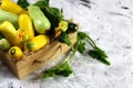 Squash Marrow organic zucchini in a wooden box with blossom and green leaves on a light background. Fresh vegetables. Flat lay. Co Royalty Free Stock Photo