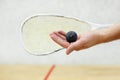 Squash player serving a ball