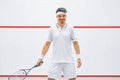 A squash player on a squash court with the racket. White sportswear. Royalty Free Stock Photo