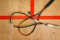 Squash rackets and ball on court floor, top view Royalty Free Stock Photo