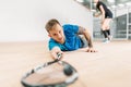 Squash training, player with racket lies on floor Royalty Free Stock Photo