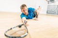 Squash training, player with racket lies on floor Royalty Free Stock Photo