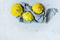Group of green and yellow pattypan squashes. Ripe squash on a gray background. Royalty Free Stock Photo