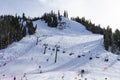 Squaw Valley Ski Resort chair lift with people sking downhill