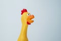 Squeaky chicken toy on a white background. Rubber toy chicken on a white background