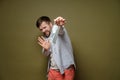 Squeamish, frightened man holds a used medical mask with two fingers and shows a stop gesture. Hysteria due to the Royalty Free Stock Photo