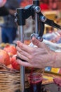 Squeeze juice from fresh pomegranates using a manual press