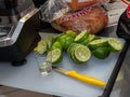 Squeezed lime, shot glass and knife sitting on small cutting board, making margaritas for party Royalty Free Stock Photo