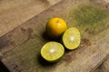 Squeezed oranges cut into two halves on a wooden cutting board Royalty Free Stock Photo