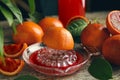 Squeezer with half of sicilian orange on wooden table Royalty Free Stock Photo