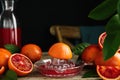 Squeezer with half of sicilian orange on wooden table, space for text Royalty Free Stock Photo