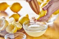 Squeezing fresh lemon juice with wooden reamer into bowl Royalty Free Stock Photo