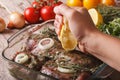 Squeezing lemon juice in the marinade for meat. horizontal Royalty Free Stock Photo