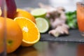 Squeezing orange juice with juicer healthy citrus fruits in background. Intake vitamins detox, healthy diet and living concept Royalty Free Stock Photo