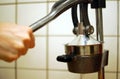 Squeezing an orange with a manual press. Royalty Free Stock Photo