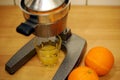 Squeezing an orange with a manual press. Royalty Free Stock Photo