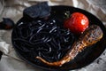 Squid ink black colored noodles with char-grilled tomato, creative