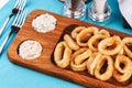 Squid rings fried in batter snack for beer with cream sauce and steamed rice Royalty Free Stock Photo