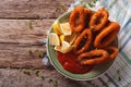 squid rings fried in breadcrumbs close-up with ketchup. horizontal top view Royalty Free Stock Photo