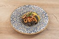 Squid risotto nero stewed with red onion and battered squid rings