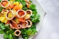Squid salad and fresh vegetables on a plate