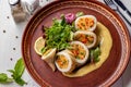 Squid stuffed with couscous and vegetables served with sauce and green salad, Closeup, Restaurant menu, Horizontal format Royalty Free Stock Photo