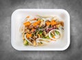 Squid with vegetables in Teriyaki sauce. Healthy diet. Takeaway food. Eco packaging. Top view, on a gray background