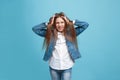 The squint eyed teen girl with weird expression isolated on blue Royalty Free Stock Photo