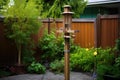 squirrel proof bird feeder on a garden pole Royalty Free Stock Photo