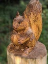 Squirrel wooden sculpture with nut and big tail Royalty Free Stock Photo