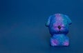 Squish toy. Dog closes its eyes with its paws on a blue background. Copy space.