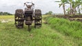 SRAGEN, INDONESIA Ã¢â¬â MARCH 12, 2022: The tractor is in a dirty condition after being used to plow the fields against
