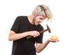 Sreaming man trying break piggy bank with hammer