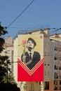 Graffiti of a women soldier with a carnation flower in her gun on an apartment building in Lisbon