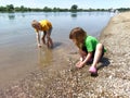 Sremska Mitrovica, Serbia, August 07, 2020. A boy and a girl are playing on the beach. Children play with water, sand and pebbles Royalty Free Stock Photo