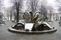 Sremska Mitrovica, Serbia 01.27.2023 City Fountain Stone flower in the central park. Snow cloudiness in winter. Snow