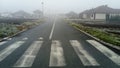 Sremska Mitrovica, Serbia, January 14, 2020, Pedestrian crossing in the fog. Asphalt road stretching into the distance. In the