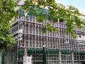 Sremska Mitrovica, Serbia, May 30, 2020. Construction of a new school building. Scaffolding on the facade. Metal fence.