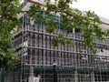 Sremska Mitrovica, Serbia, May 30, 2020. Construction of a new school building. Scaffolding on the facade. Metal fence